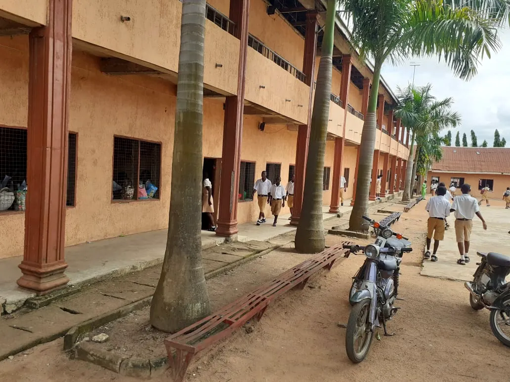 Students walking along the corridor of the main classroom block